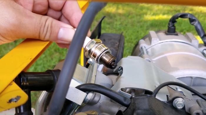 checking the spark plug on a portable generator